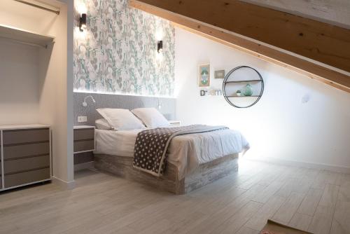 a bedroom with a bed and a mirror on the wall at BeSalamanca in Salamanca