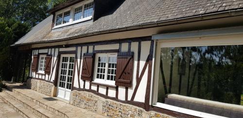 a house with a black and white building at Pré Le Duc in Broglie
