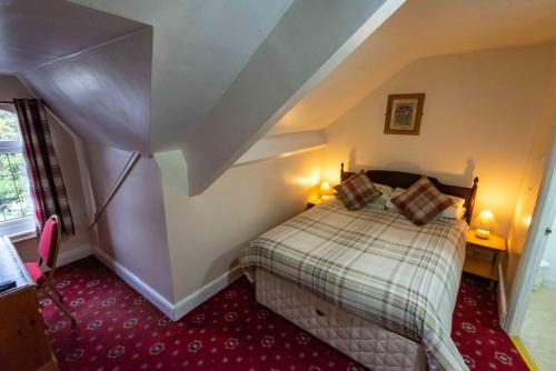 a bedroom with a bed in a attic at Aarondale Guest House in Hartlepool