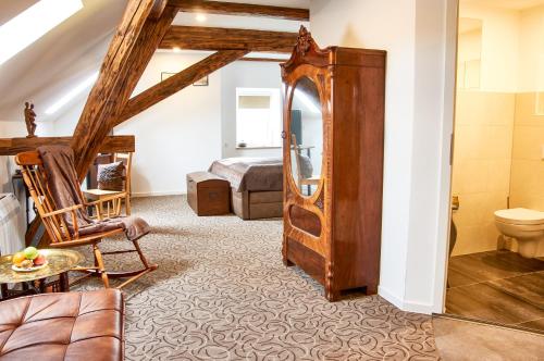 a living room with a couch and a bedroom at "Alte Pension" Bautzen in Bautzen