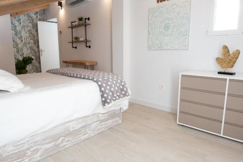 a bedroom with a bed and a dresser at BeSalamanca in Salamanca
