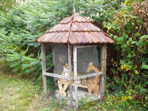 two giraffes sitting in a bird cage at Maison du Moulin Galuzot in Saint-Vallier