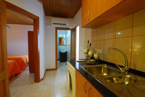 a kitchen with a sink and a counter top at Alojamentos Flores Island in Faja Grande