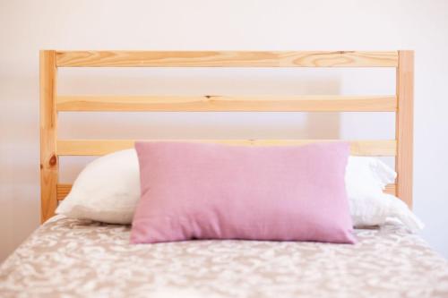 a pink pillow sitting on top of a bed at Valle Fiorita in Castro dei Volsci