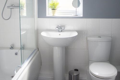 a white bathroom with a sink and a toilet at Appleby Darlington in Darlington