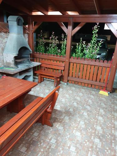 an outdoor patio with benches and an outdoor stove at Terme Čatež Apartma Nine in Čatež ob Savi