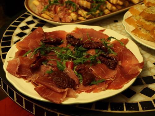 a plate of food with meat and greens on a table at Apartmány č.p. 9 in Kouřim