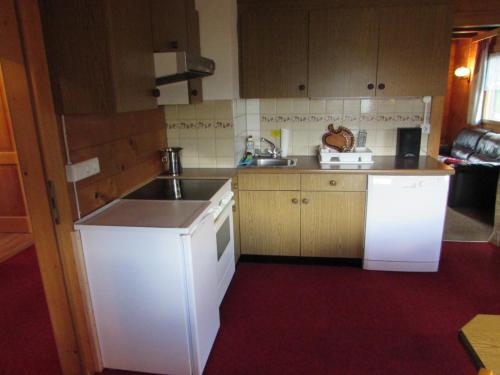 a small kitchen with a sink and a stove at Gauertalhaus - Vollspora in Schruns-Tschagguns