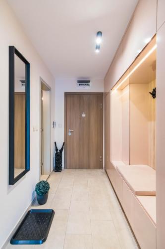 a hallway with a wooden door and a black rug at Kapana Luxury City Center Apartments with Garage in Plovdiv