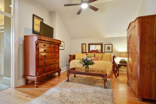 a bedroom with a bed and a dresser at Maison Perrier Bed & Breakfast in New Orleans