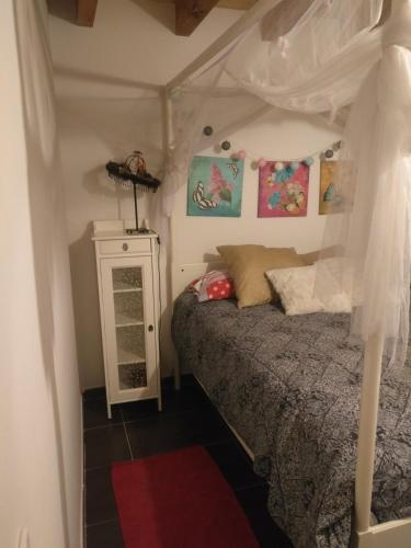 a bedroom with a bed with a canopy at LA LOBERA (VALLE DEL TIETAR) in La Iglesuela