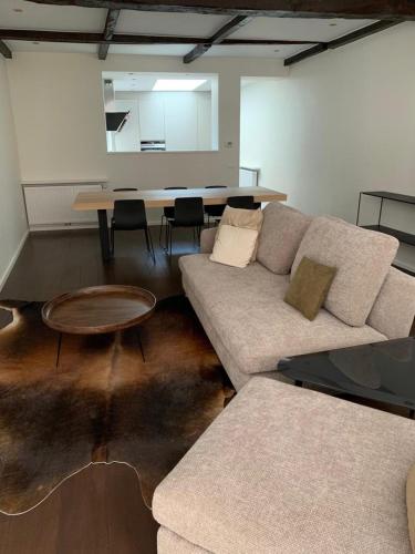 a living room with a couch and a table at Entire House In Centre of Ghent in Ghent