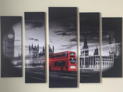 a red bus in the city of london with big ben at My SmartApart Hotel Today in Kyiv