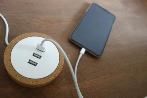 a computer mouse sitting on a table next to a tablet at R Guest House in Osaka