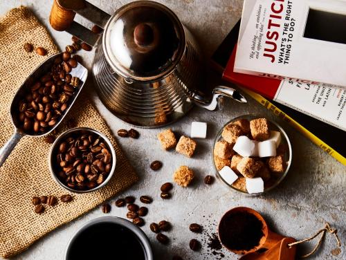 a table with coffee beans and a cup of coffee at LAMP LIGHT BOOKS HOTEL nagoya in Nagoya