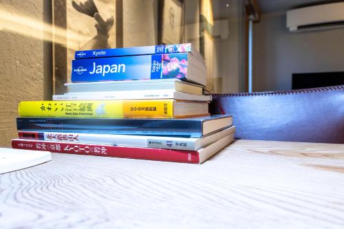 a stack of books sitting on top of a table at Luxury Condo Shikine An Gion Shirakawa in Kyoto