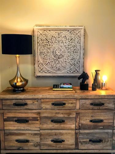 a wooden dresser with a lamp on top of it at The View Lake Tekapo in Lake Tekapo