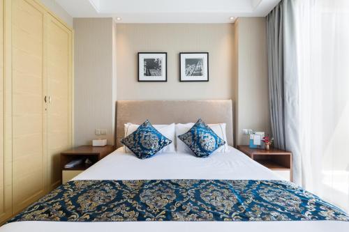 Кровать или кровати в номере Pinxiayuan Apartment in Lvcheng Resort