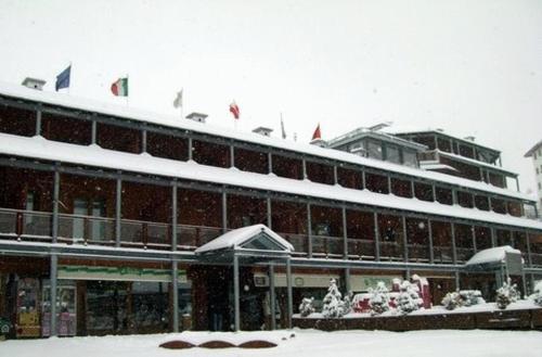 a large building with snow on top of it at Il Fraitevino hotel bed & breakfast in Sestriere