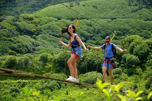two people on a zip line in the mountains at Seaview Kite Studio - La Gaulette in La Gaulette