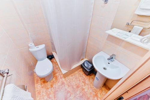 a bathroom with a toilet and a sink and a shower at City Park Hotel in Ulan-Ude