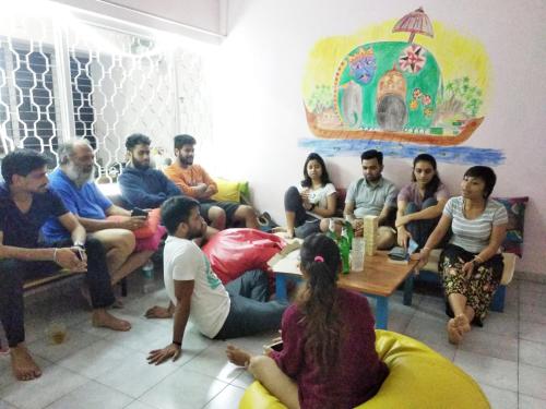 a group of people sitting in a room at Gibbon Backpackers Hostel in Guwahati