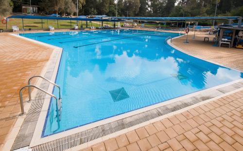 an overhead view of a large swimming pool at Zohar Badeshe in Daliyya