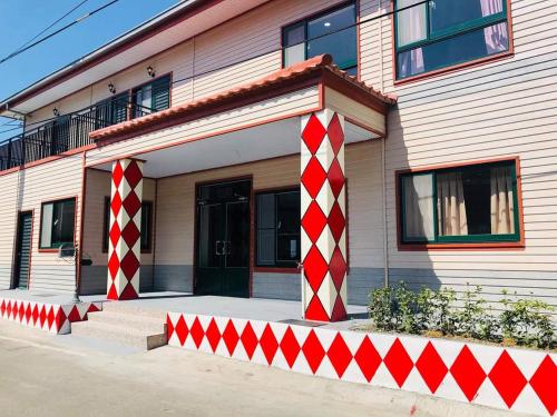 a house with red and white columns in front of it at 崗好山莊 in Jianshi