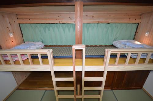 two bunk beds in a cabin with twoadders at Hanareya in Tsushima