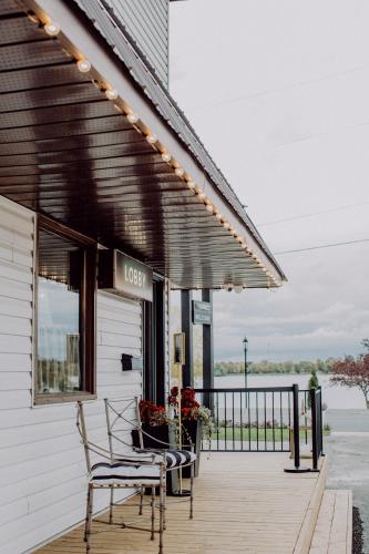 a patio with a table and chairs on a building at The Bayview Motel - Fort Frances, ON - Lakeside Motel in Fort Frances