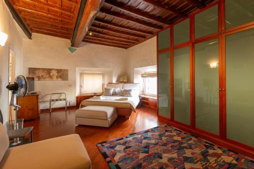 a bedroom with a bed and a couch in a room at Pantheon Palazzo Nari in Rome