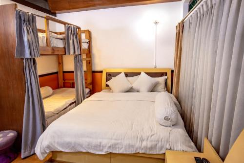 a bedroom with a bed and a bunk bed at Shangrila Boutique Hotel in Kathmandu
