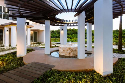 a fountain in the middle of a courtyard with a building at Belmont Hotel Boracay near Newcoast Beach in Boracay