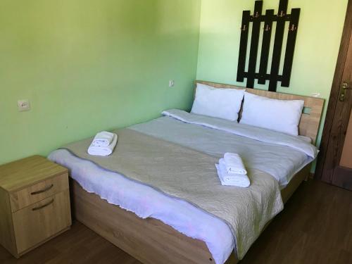 a bedroom with a bed with two towels on it at Riverside Kazbegi in Stepantsminda