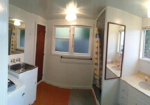 a bathroom with two sinks and a mirror at Haven on Haven in Moeraki