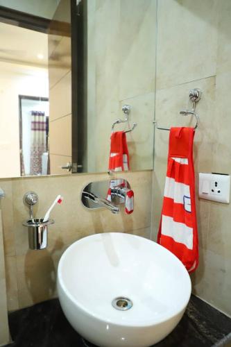 a bathroom with a white sink and a mirror at The Most Beautiful Property Of Rishikesh in Rishīkesh