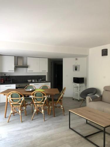 a living room with a table and chairs and a couch at Maxima Sunset in Sainte-Maxime