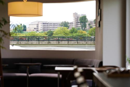 a window in a room with a view of a bridge at sararaso in Kanazawa