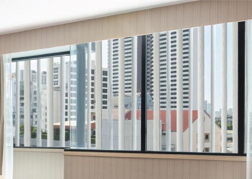a window of a building with tall buildings at Eleven Hotel Bangkok Sukhumvit 11 in Bangkok