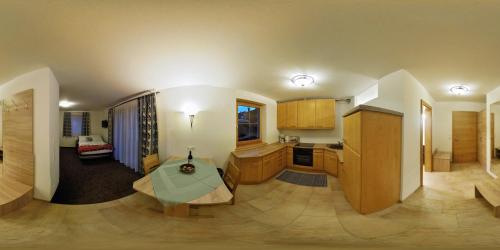 a kitchen and living room with a table in a room at Appartements Fritzhof in Kirchberg in Tirol