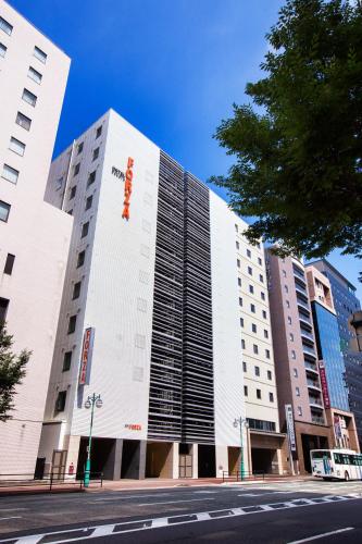 a large white building with a red sign on it at HOTEL FORZA HAKATAEKI CHIKUSHI-GUCHI Ⅰ in Fukuoka