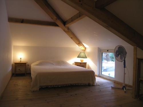 a bedroom with a white bed and a window at Les Villas de Messanges in Messanges
