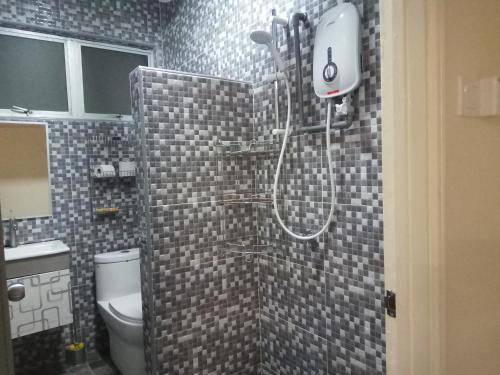 une salle de bain avec douche et toilettes dans l'établissement Aiman Homestay Port Dickson, à Port Dickson