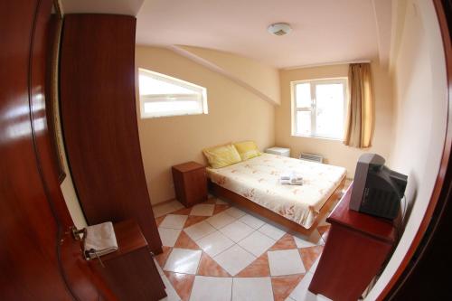 a small bedroom with a bed and a window at Villa D&L in Ohrid