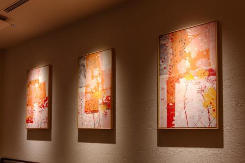 three paintings hanging on a wall in a room at HOTEL FORZA HAKATAEKI CHIKUSHI-GUCHI Ⅰ in Fukuoka