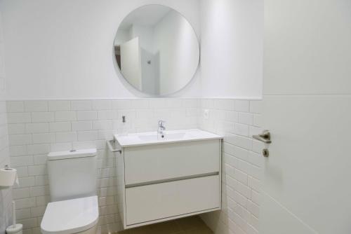 uma casa de banho branca com um lavatório e um espelho em Córdoba COol en Pleno Centro de Córdoba em Córdoba