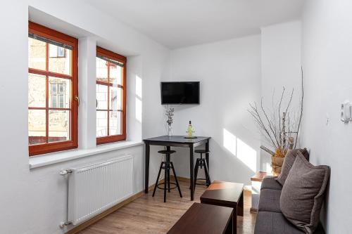 a living room with a couch and a table at Penzion Maxwilliam in Znojmo