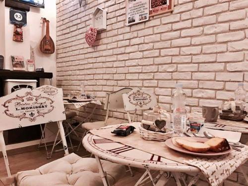 a room with a table and chairs and a brick wall at B&B La Maison Del Borgo Antico in Bari