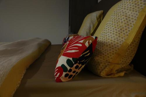a bed with two pillows on top of it at Résidence la floraison in Brussels