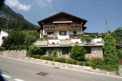a house with a balcony on the side of a road at VillaGiardino - Lake in Molveno